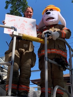 Firefighter posing with Sparky